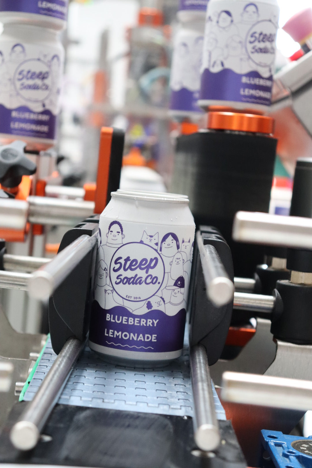 Sleepy Soda Co. Blueberry Lemonade cans on a production line.